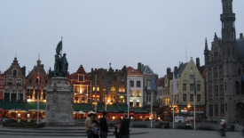 The central market square, or Grote Markt, in Bruges at dusk on a summer night.
